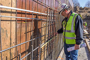Building official inspecting a wall