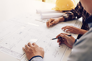 Two people reviewing building plans.